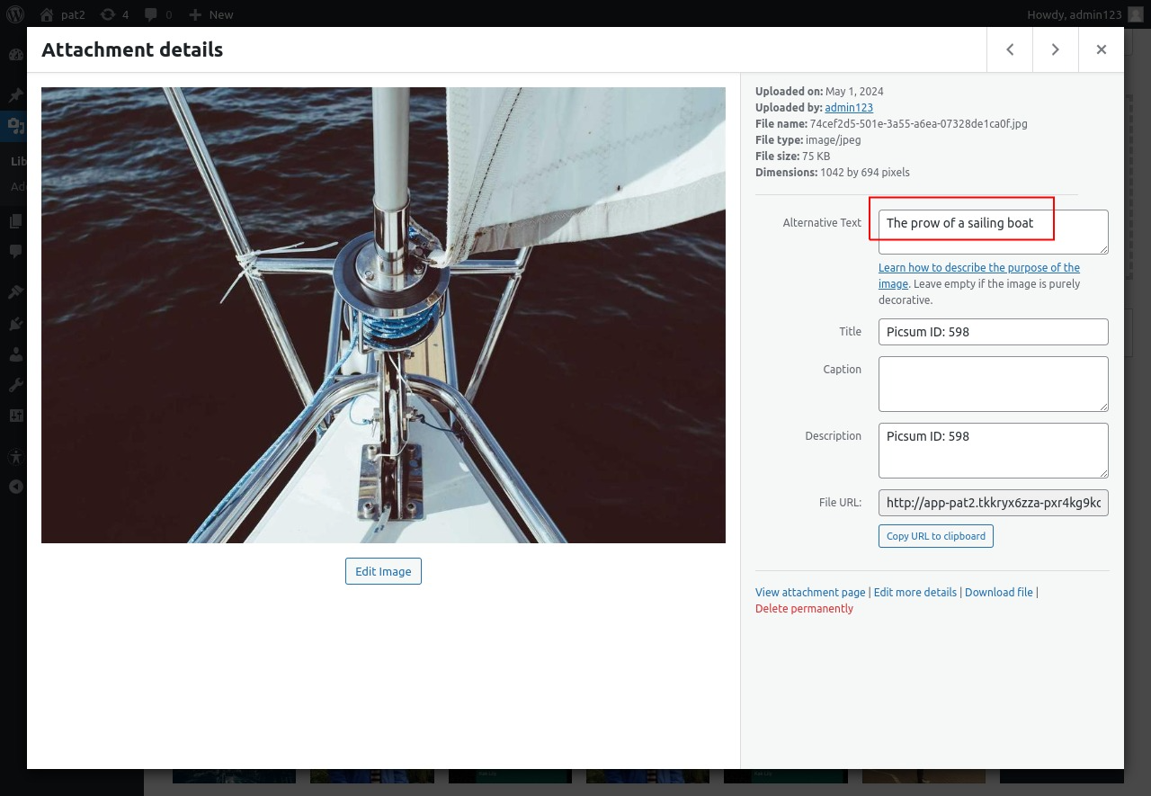WordPress Attachment details window: an image of a sailing boat's prow on the left, and on the right the Alternative Text field, outlined in red, containing "The prow of a sailing boat", above the Title, Caption and Description fields